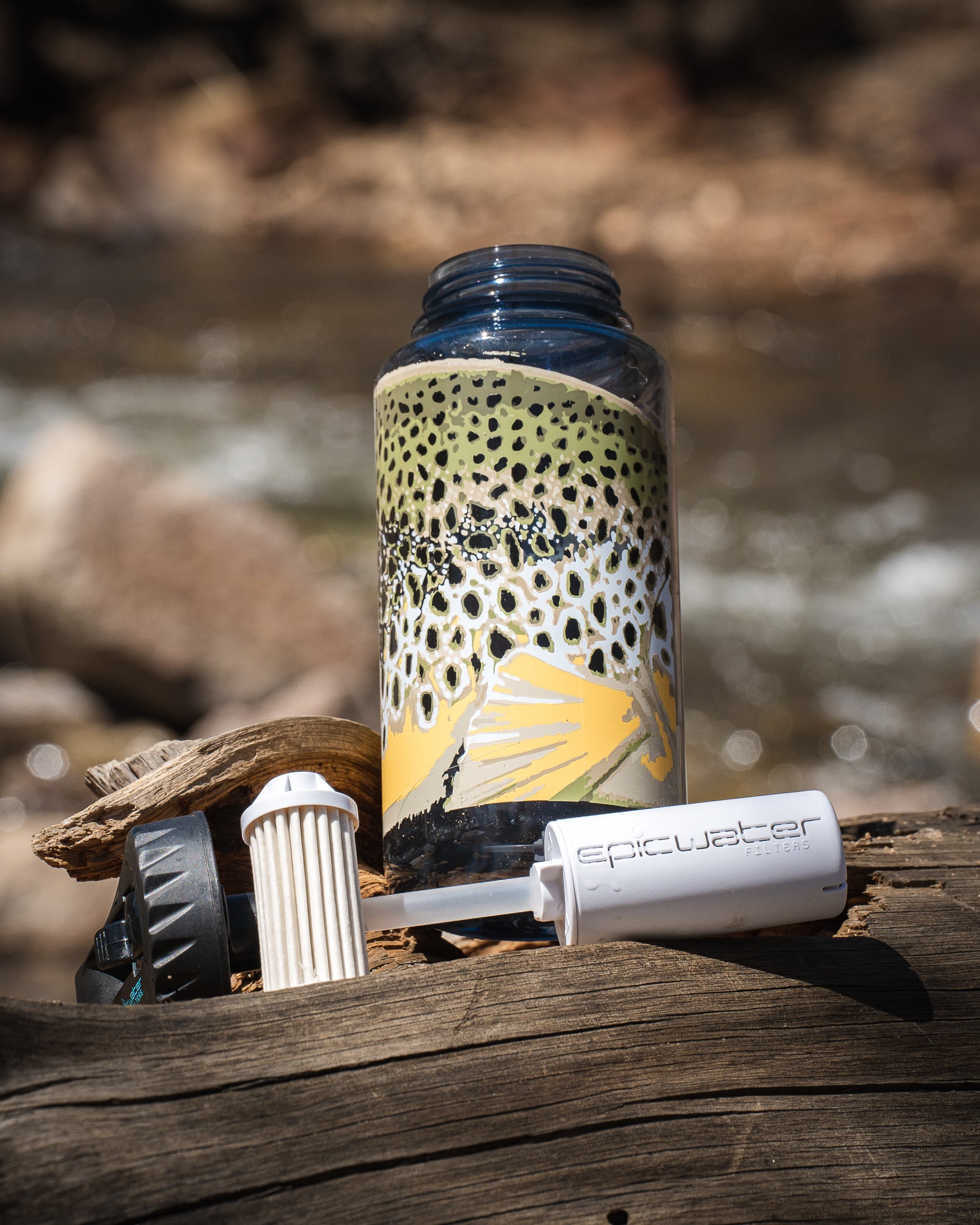 Plastic water bottle featuring a brown trout design showcasing the Epic everywhere filter system in front of a stream background.