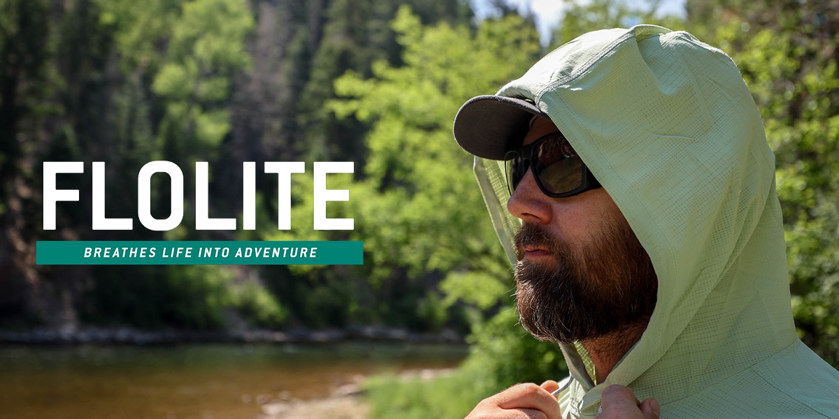 Person wearing sunglasses, a cap, and a light green hooded jacket standing near a river with trees in the background. Large text on the image reads ‘FLOLITE’ with a tagline underneath that says ‘Breathes Life Into Adventure".
