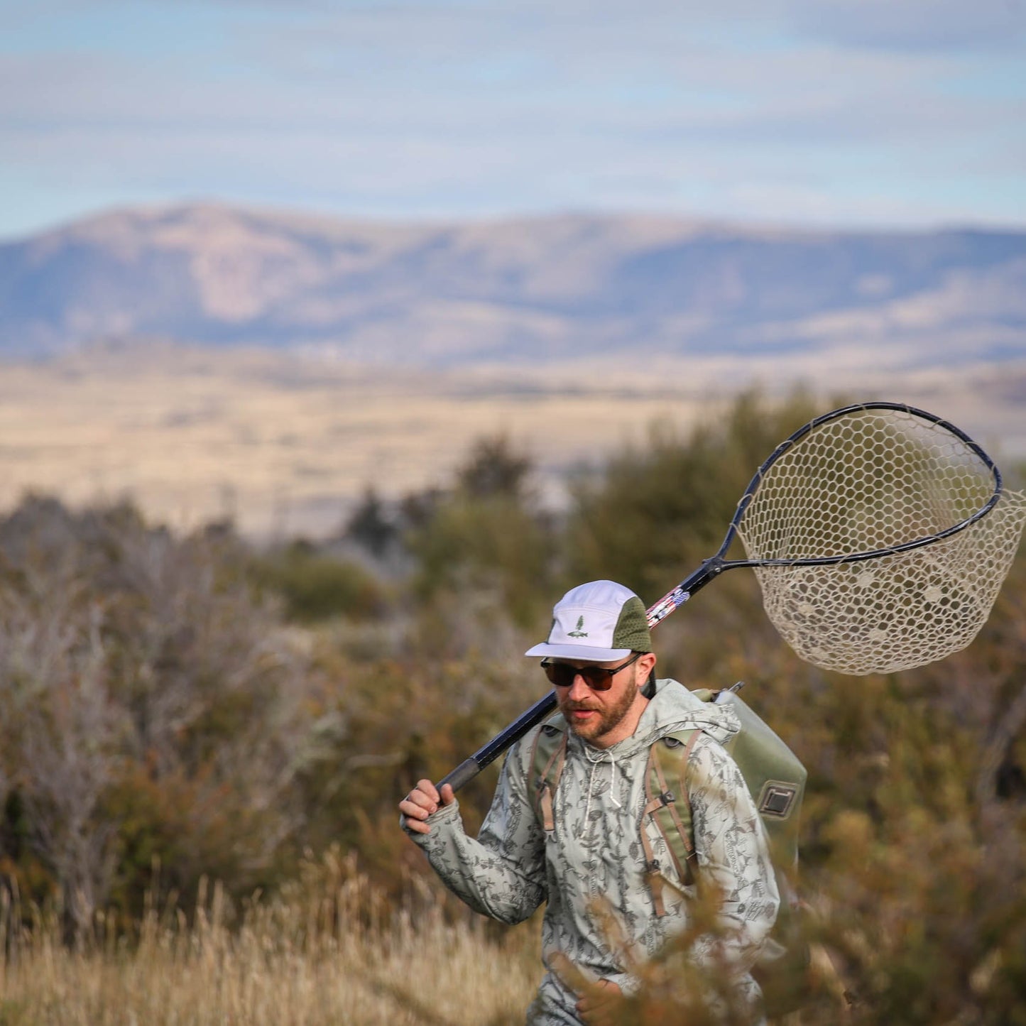 Man wearing fly fishing roots camp hat by repyourwater