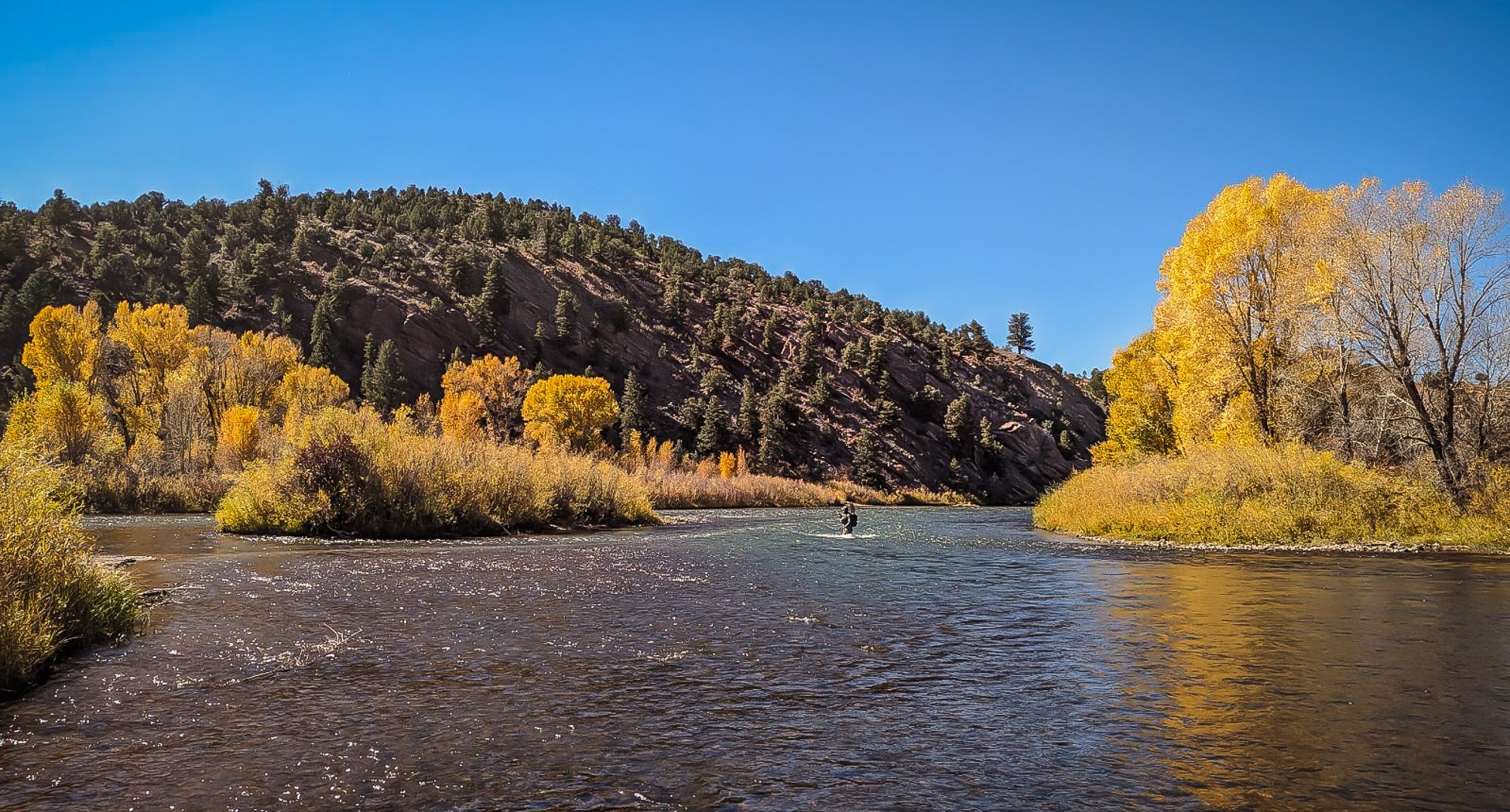 A man walks through a river