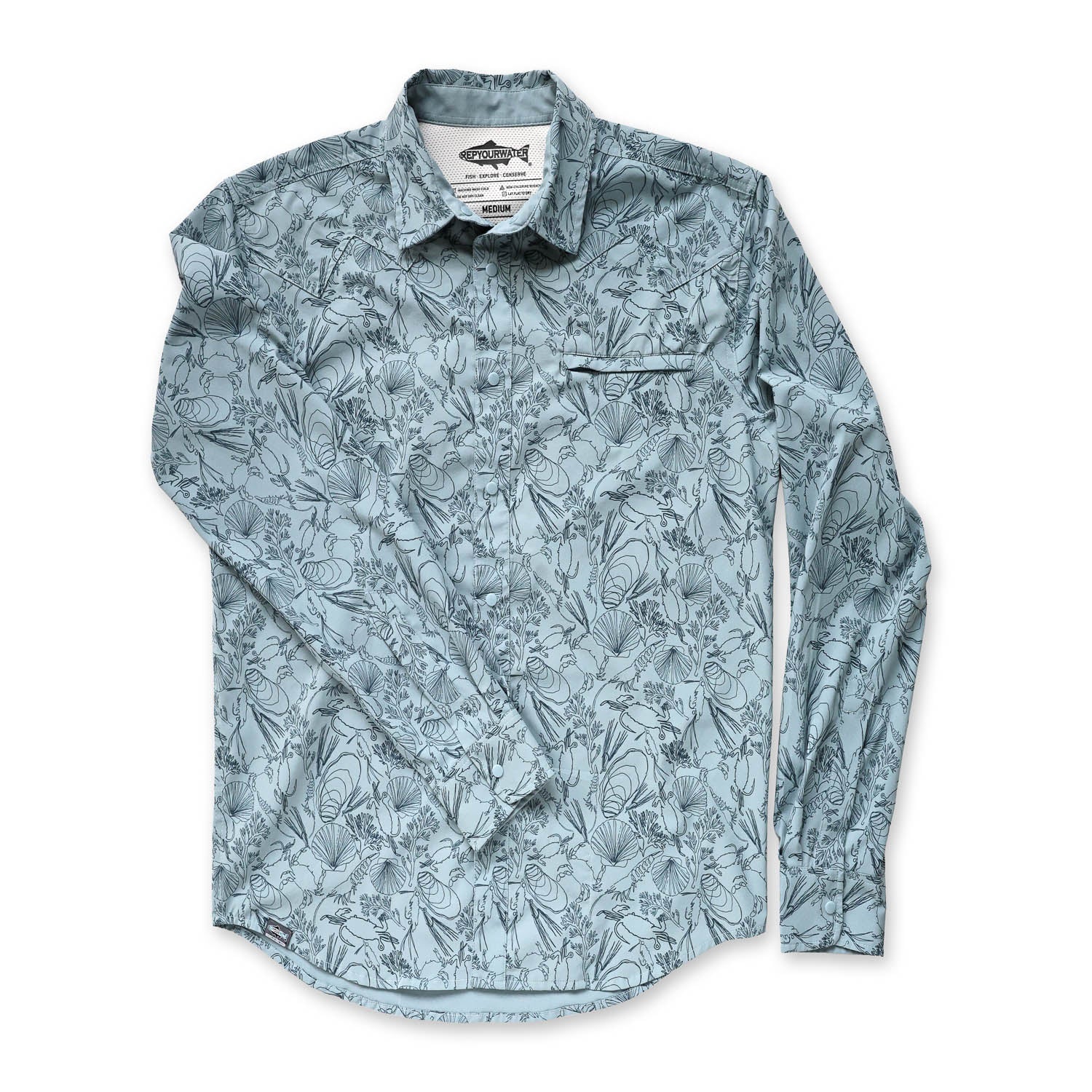 Front of light blue longsleeve button down back with a pattern of the sea floor on it on a white background