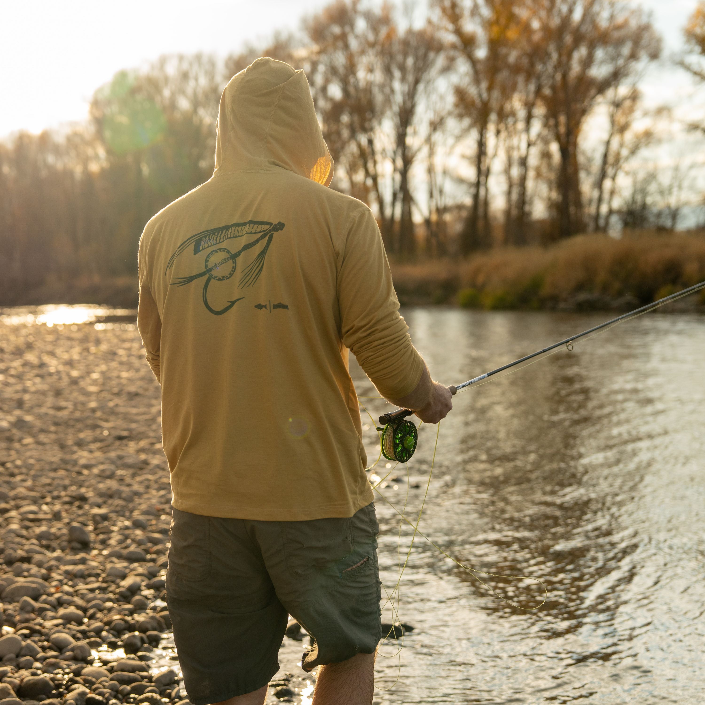 man in water fishing with banjo fly sun hoody merino breeze infamous string dusters collaboration