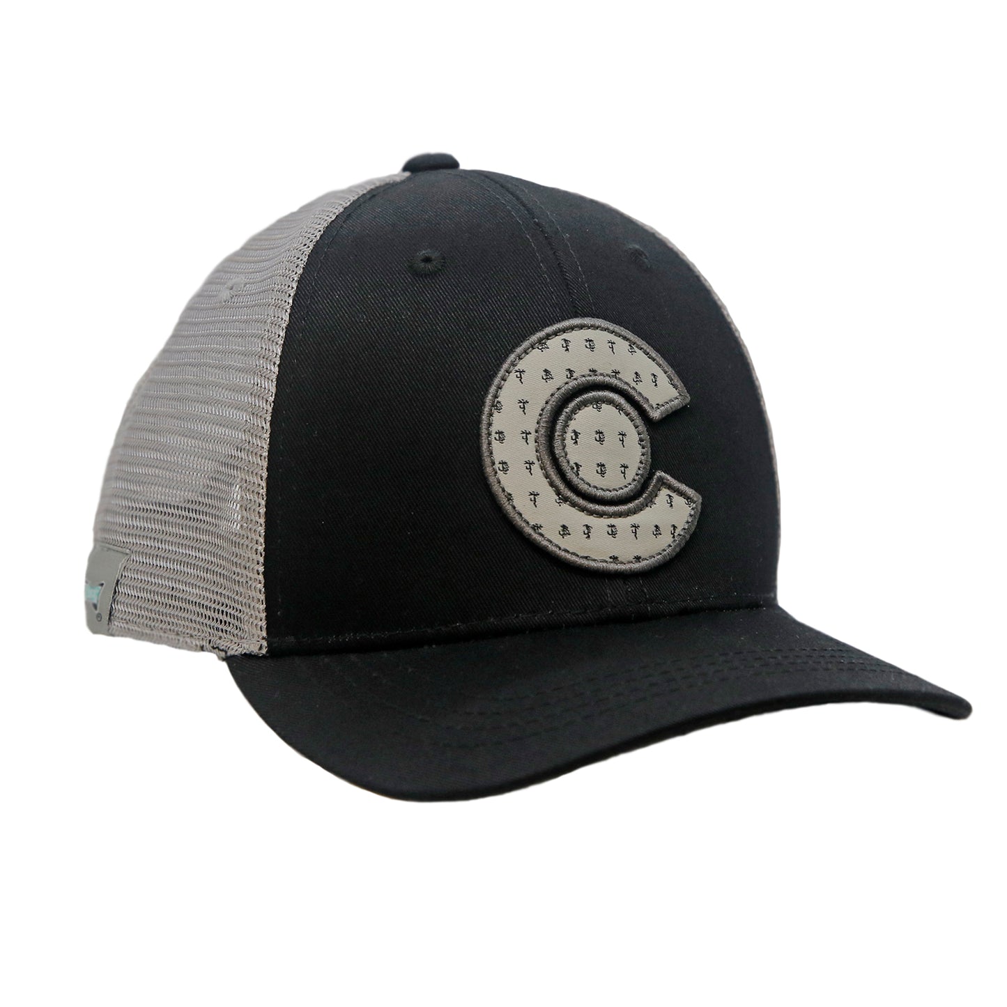 A hat with gray mesh and black front fabric has a patch in the shape of the letter C with a circle in the middle. Both parts of the patch have a print of dry flies repeated throughoutule