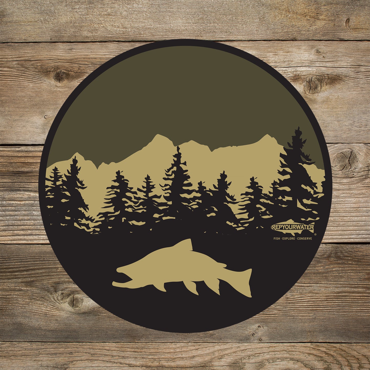 A wood background has a mockup of a circular sticker which has a trout in front of pine trees and a mountain. A logo that reads repyourwater inside a trout silhouette is above the words fish explore conserve