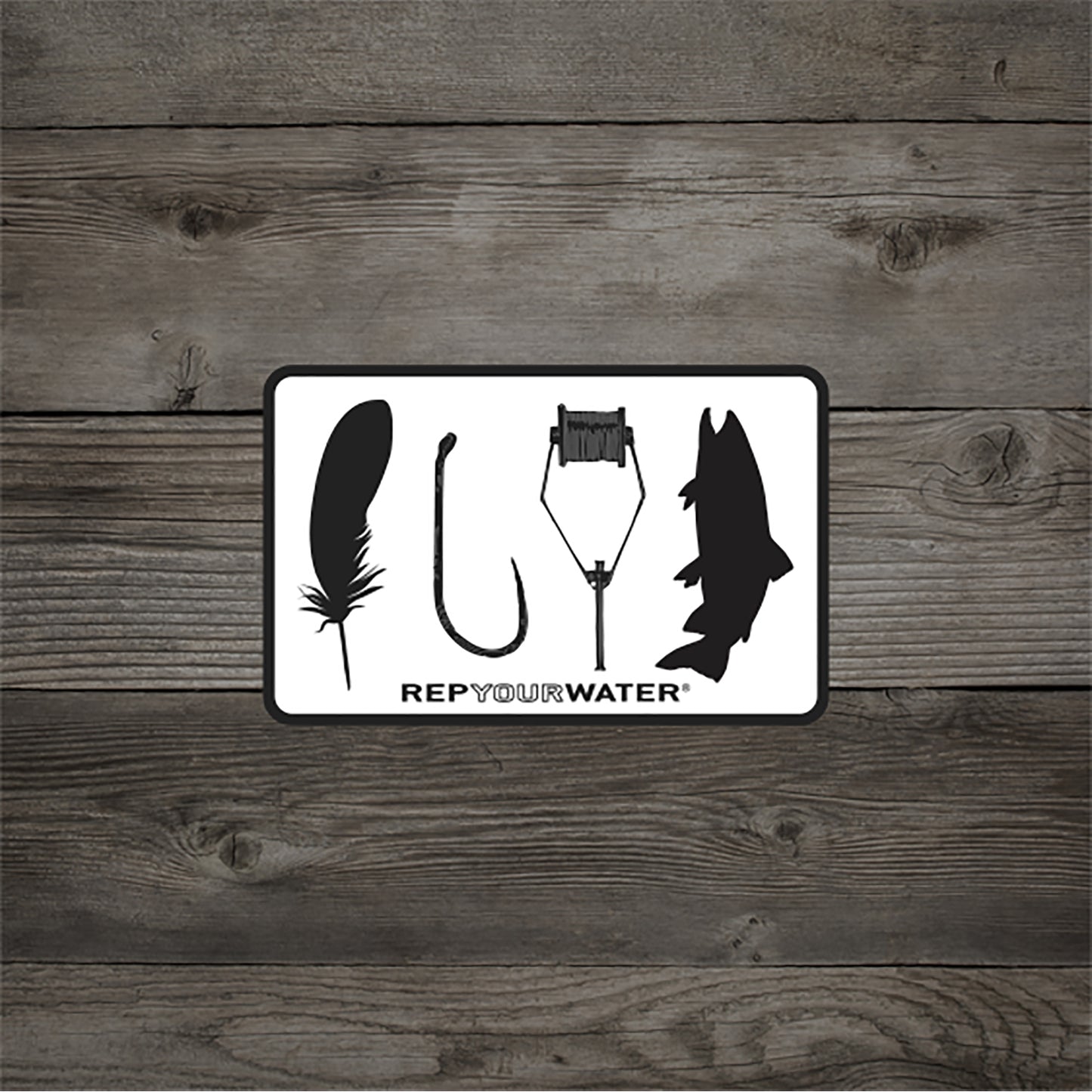 A wood background white sticker with black border that shows the silhouettes of a feather hook bobbin and trout with text that reads rep your water