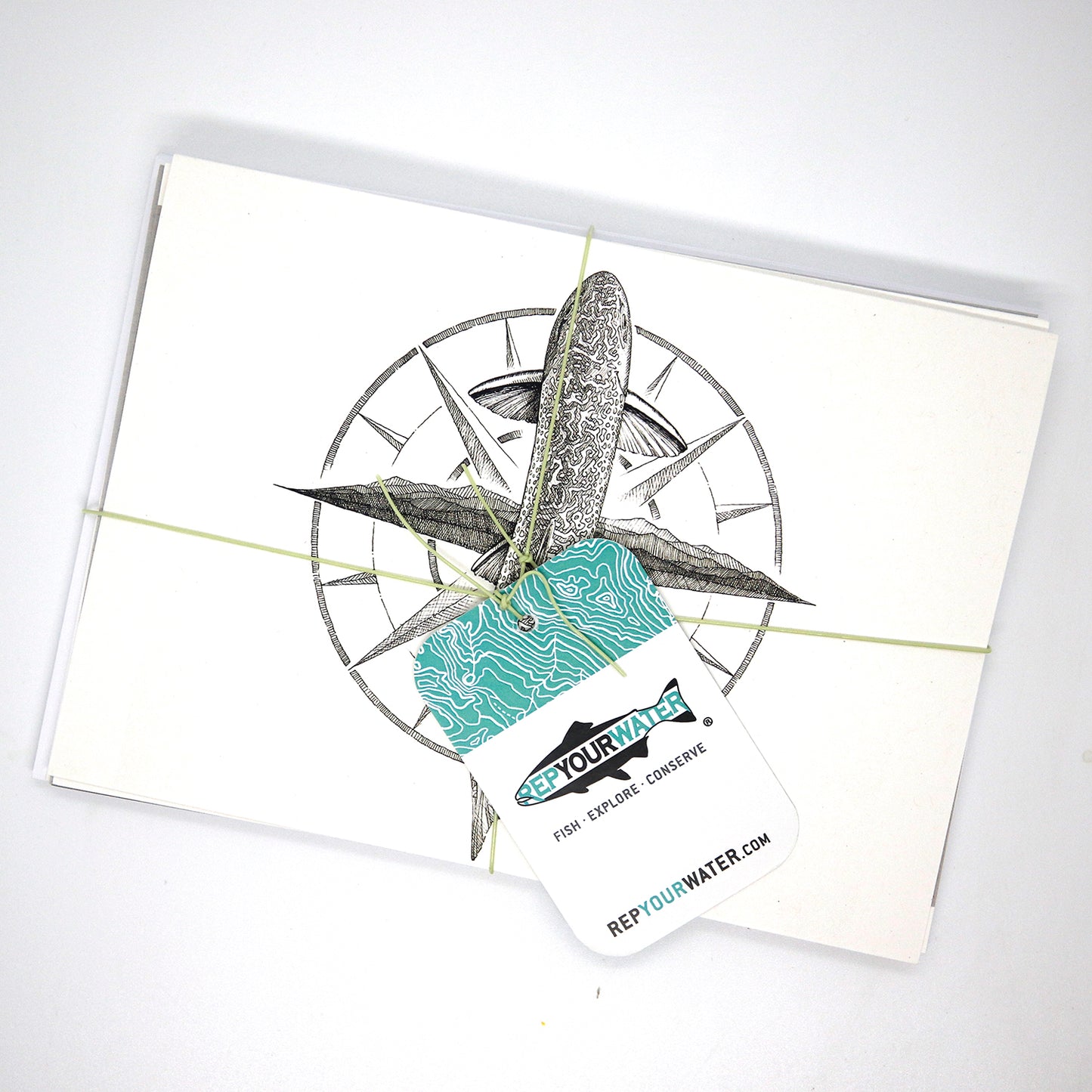 One stack of greeting cards with the same hangtag in the first image. This only shows ta brook trout drawing with a compass