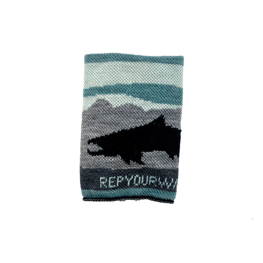 a knitted tube for cans and bottles features a black trout in front of a blue sky and gray mountain scene it features the words rep your water underneath