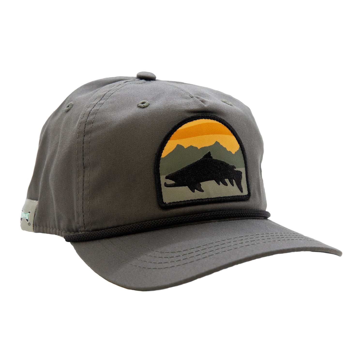 A gray hat with a brim has a patch with a trout in front of a mountain and suns et scene