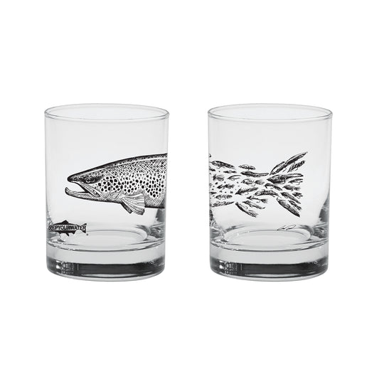two sides of a cocktail glass are shown with a brown trout fading into fishing flies