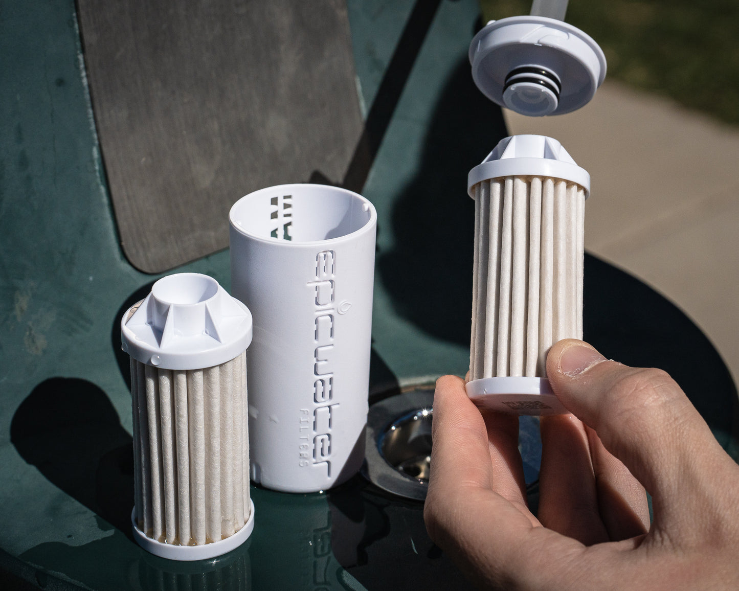Everywhere filters and housing shown with straw attachment for water bottle.
