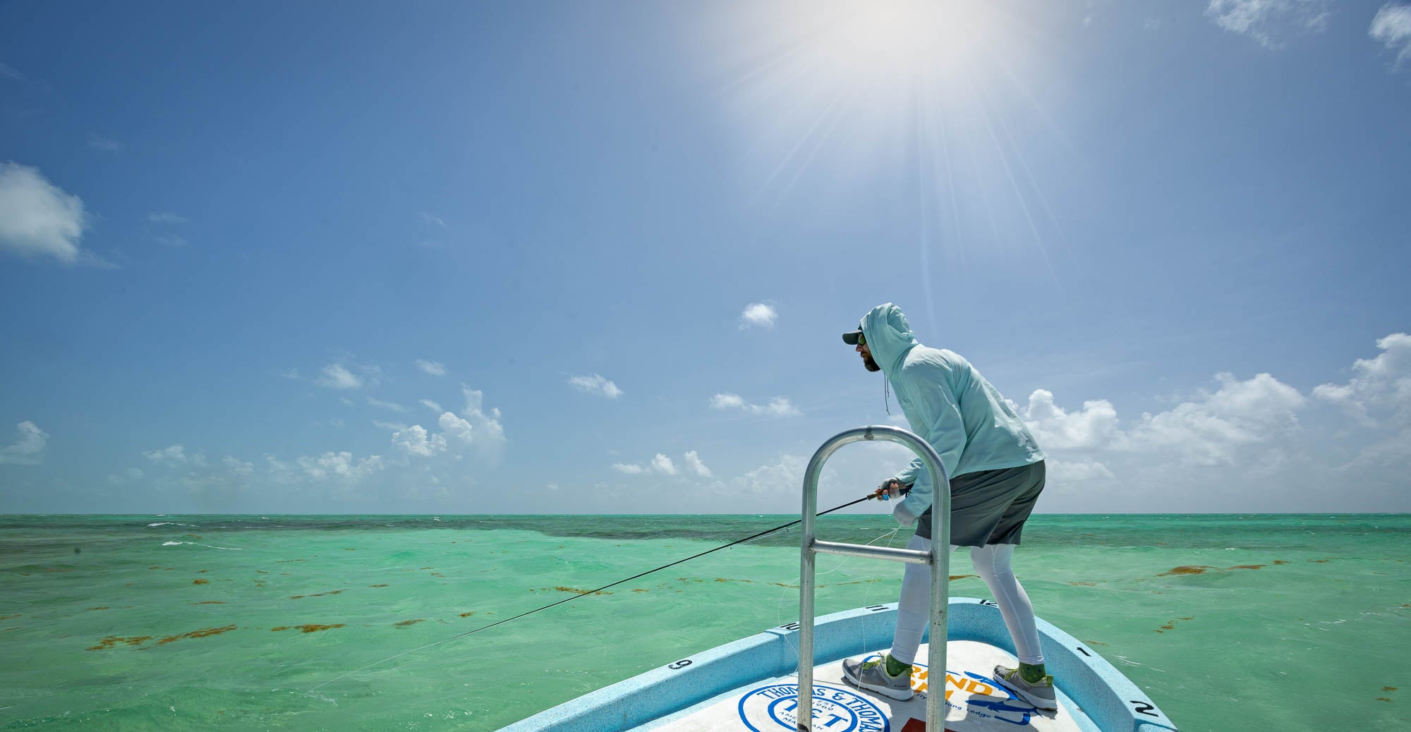 man on a boat fly fishing in mexico