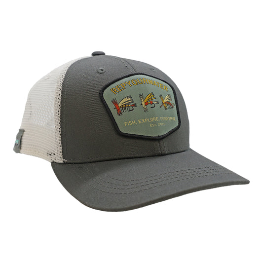 A hat with white mesh back and gray front. The front fetures a patch that says RepYourWater, fish explore conserve, and est 2011 with 3 dry flies.