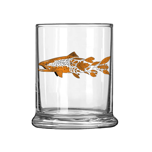 Low ball glass with brown trout transitioning into autumn leaves orange and black ink