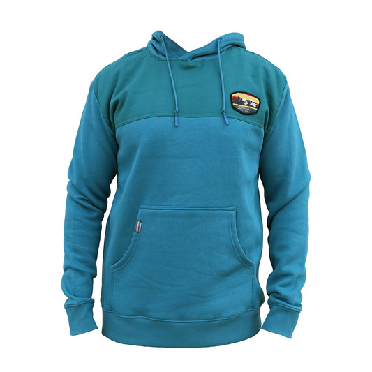 Blue hoodie with a sunset and mountain patch on the chest against a white background
