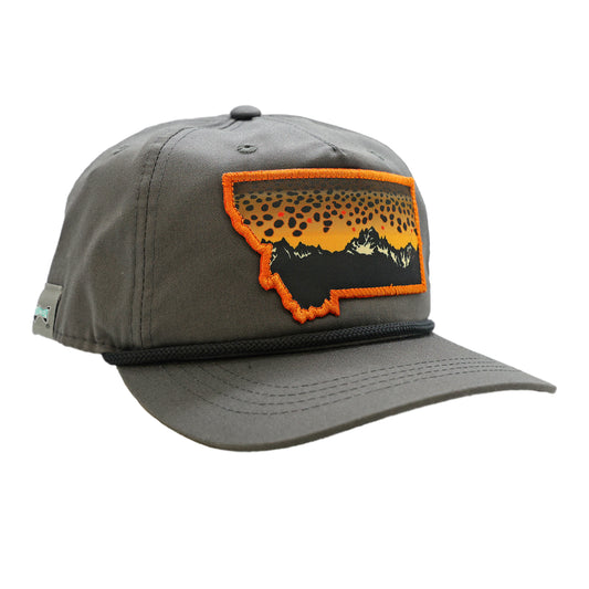 A gray hat with a black rope featuring a montana outline filled with a brown trout skin design and mountains.