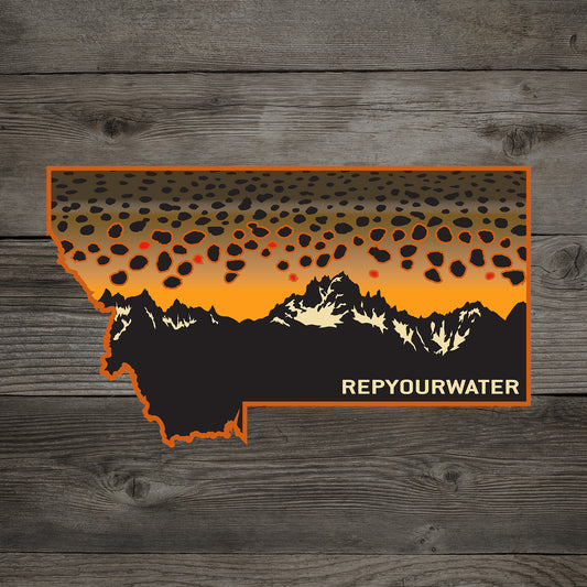 A sticker shsaped as montana with a brown trout pattern sunset and a mountain range in black and white with repyourwater in the bottom right