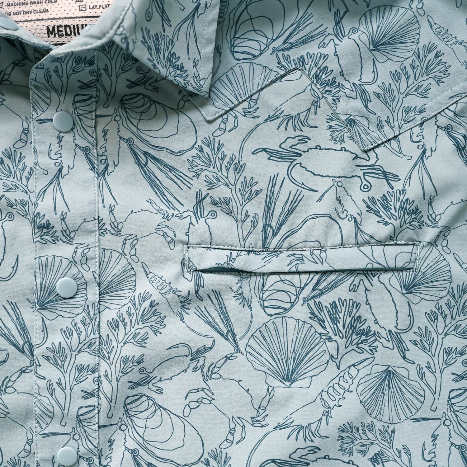 Close-up of a longsleeve button down shirt with marine life pattern
