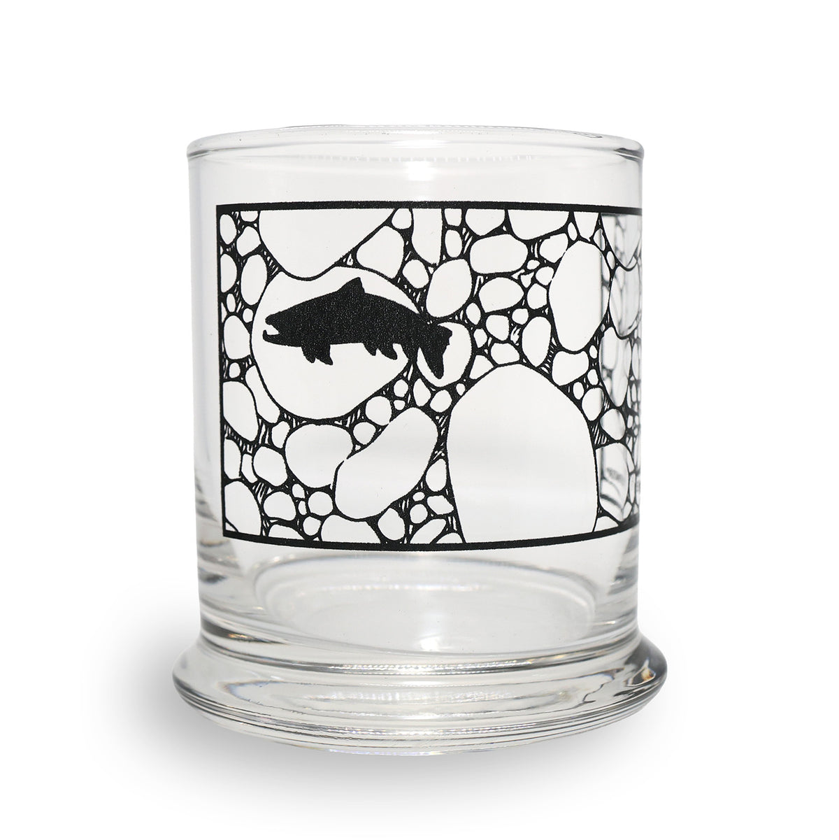 A clear glass tumbler with a black printed graphic of a fish swimming over a pattern of white stones, shown on a plain white background.