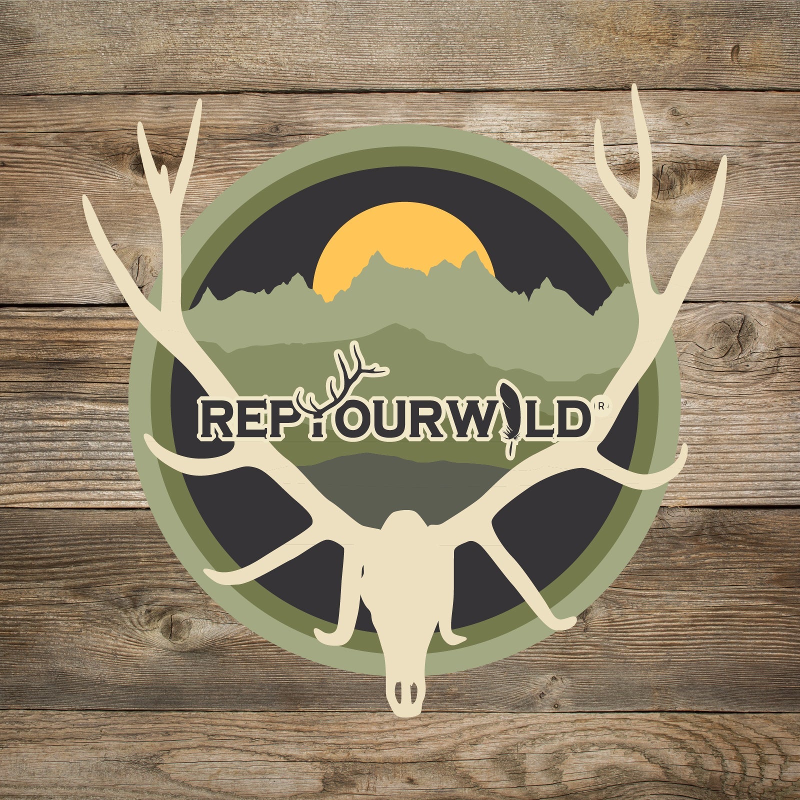 Sticker Round green black and tan colors with sun behind mountains with elk skull and antlers words rep your wild in the middle