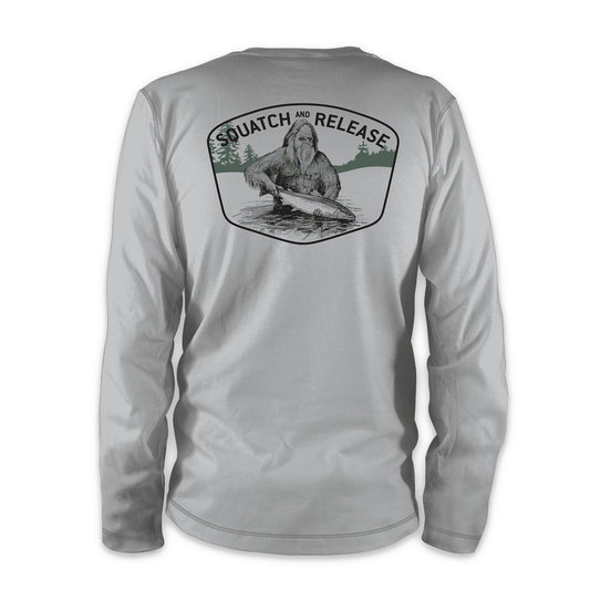 The back of a gray shirt shows a sasquatch holding a fish above the water underneath the words squatch and release