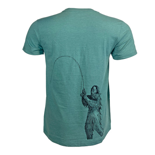Blue green tee shown from the back with artistically rendered fishing sasquatch on the wearers lower right back.