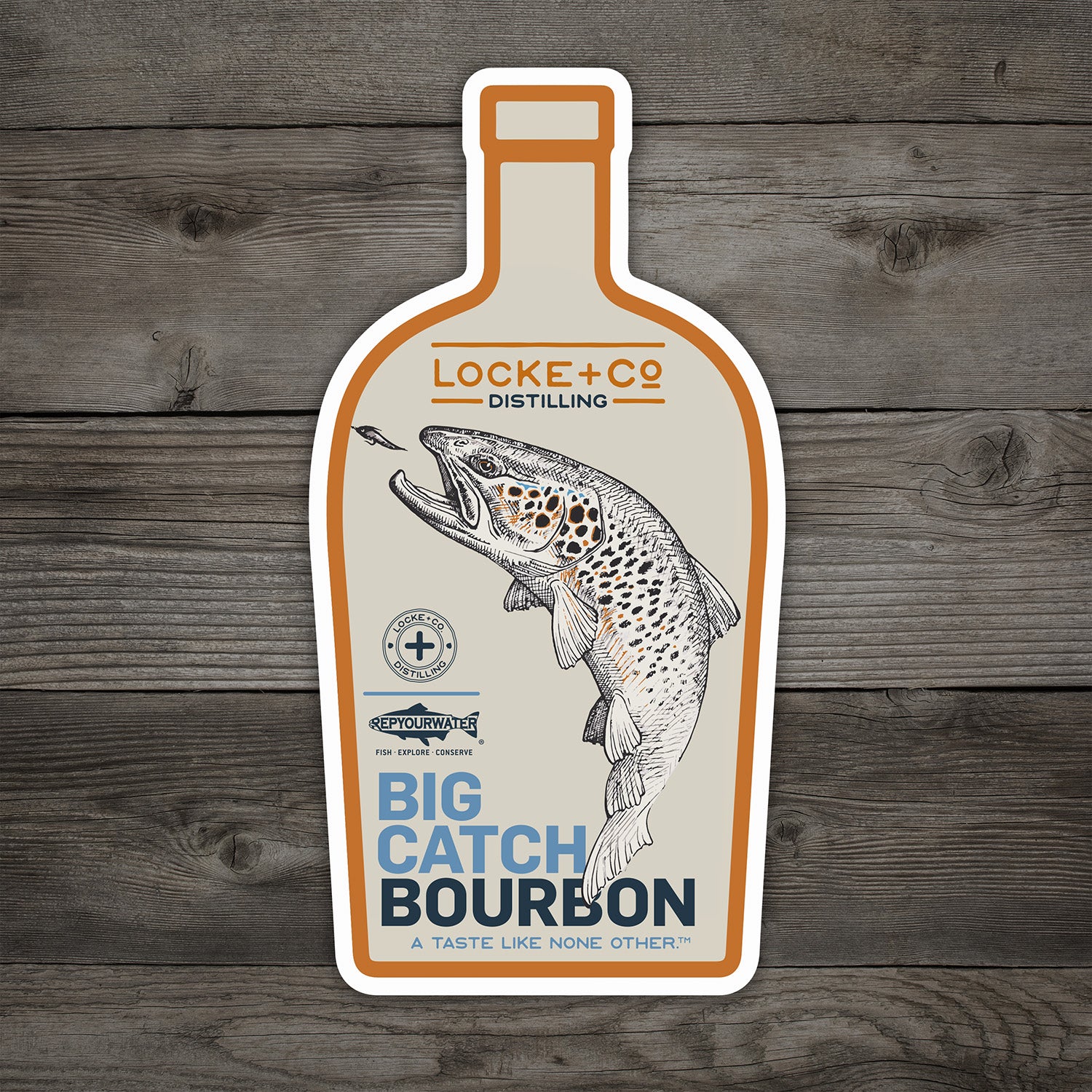Bottle-shaped sticker featuring a fish illustration and text reading ‘Locke + Co Distilling Big Catch Bourbon.’