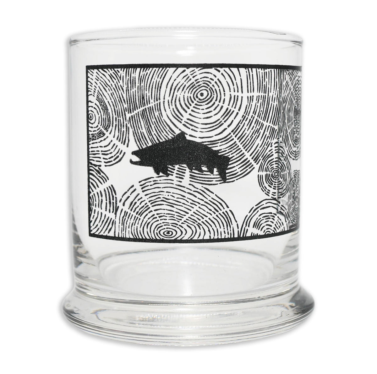 Glass with a square filled in with tree ring pattern and a black silhouette of a trout on it. All in black ink. 