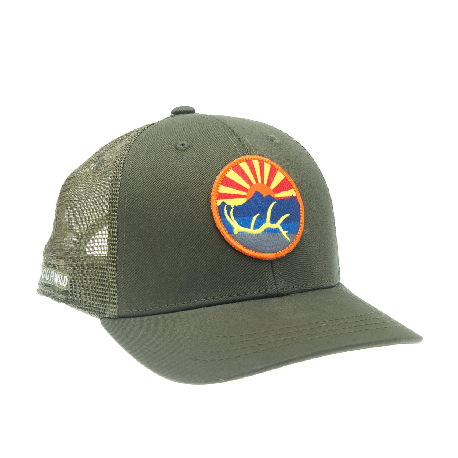 A hat with green mesh in the back with green fabric in the front has a circular patch on front with an elk antler, in front of a mountain and sunset