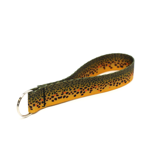 A nylon loop with a pattern of brown trout skin is connected to a silver key ring