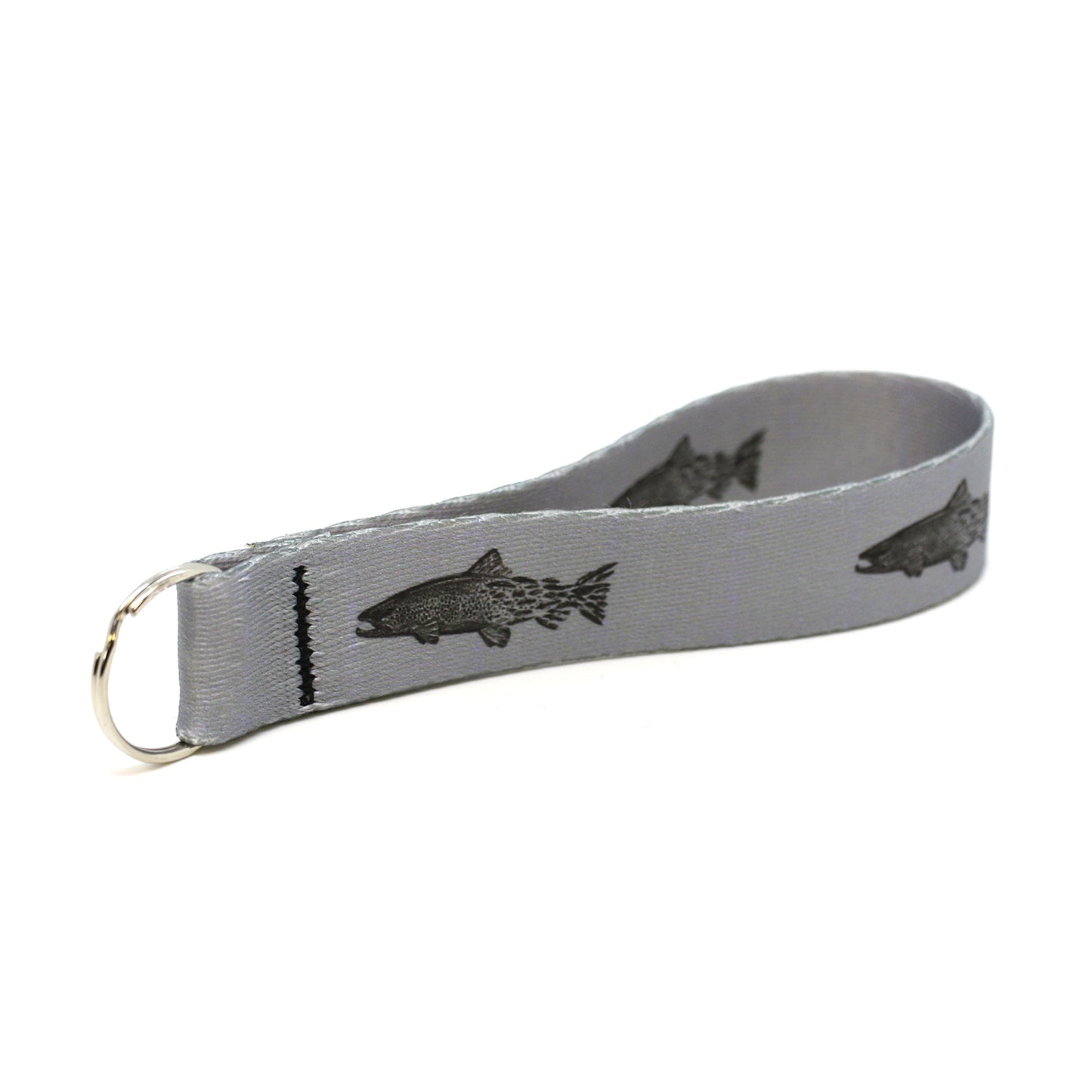 gray key fob with repeated pattern of a brown trout transitioning into flies towards the tail with metal ring 