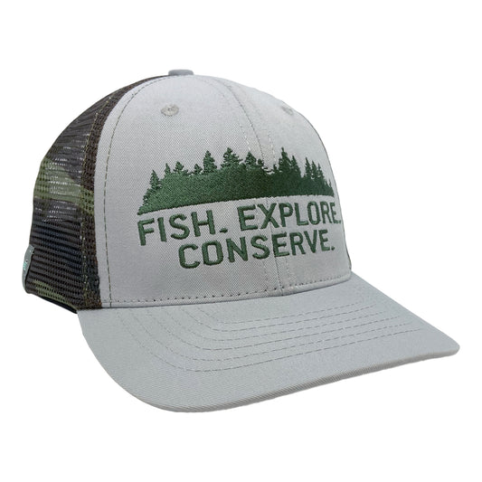 A hat with camo mesh in the back and gray fabric on the front has embroidery of pine trees above the words fish explore conserve