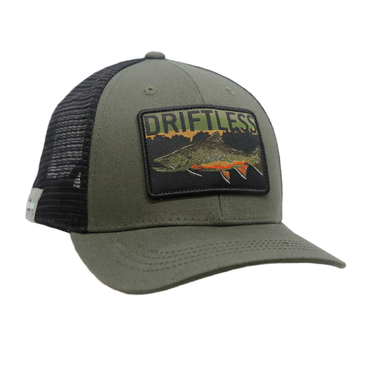 A hat with black mesh in back and green fabric in front has a rectangular patch that says driftless and has a brook trout in front of trees