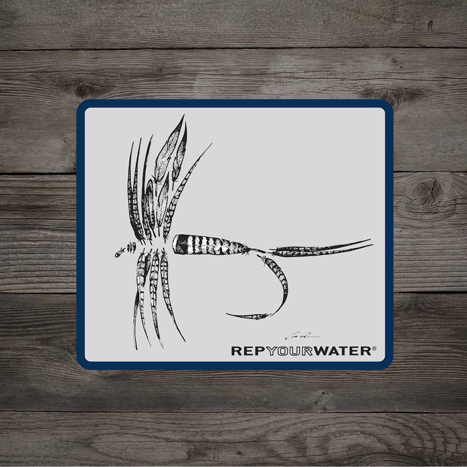 A wood background white sticker with blue border of a dry fly made up of various feathers with text that reads rep your water
