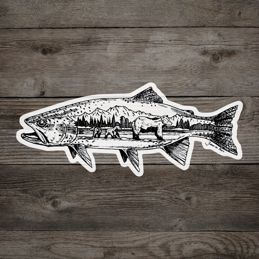 A sticker on a wood background. Sticker is a print of a drawing of a trout with a family of bears inside of the fish.