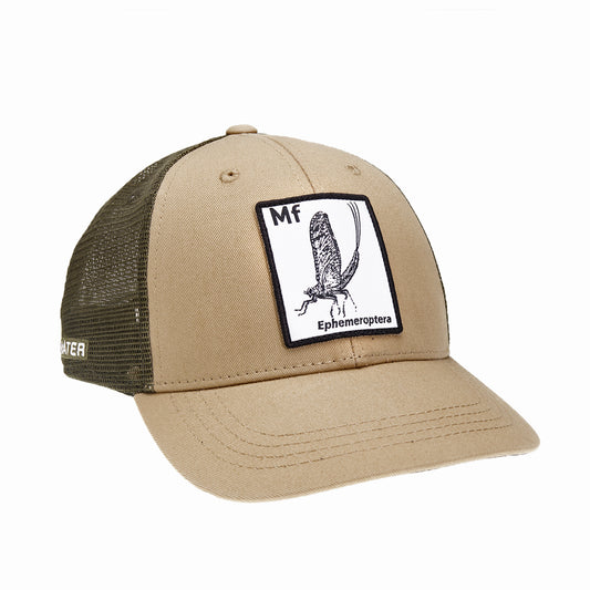 A hat with green mesh in the back and tan fabric in the front has a rectangular patch with a drawing of a mayfly on it with the letters MF above it and the word ephemeroptera below it