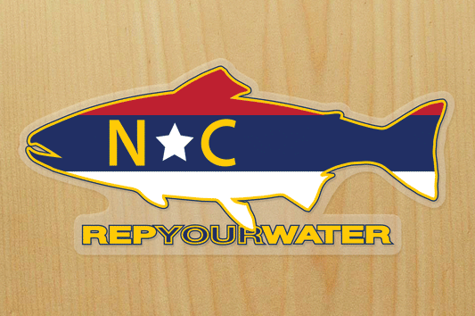 A wood background has a sticker on it which is a trout and says NC inside with the words repyourwater underneath