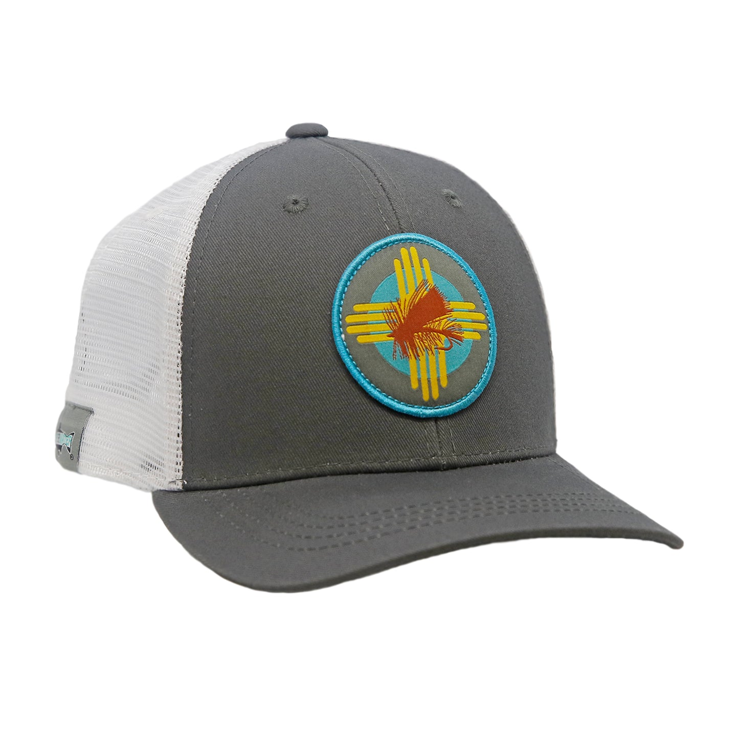 A hat with white mesh in back and gray fabric in front has a circular patch featuring a dry fly and a zia symbol