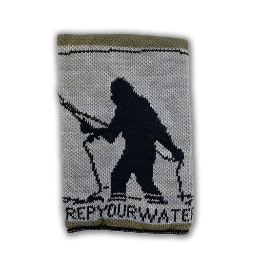 A knitted merino wool drink sweater with a sasquatch fishing on it