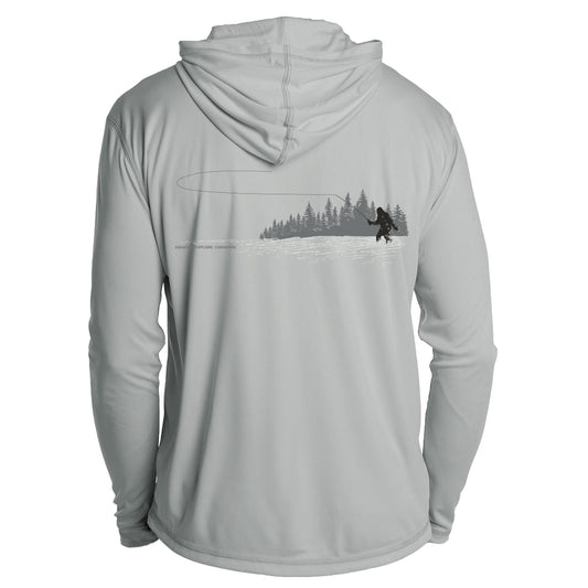 A gray longsleeved shirt with a hood has a print of a sasquatch casting a fly rod while standing in the water in front of pine trees. The words Squatch Explore Conserve are on the left side