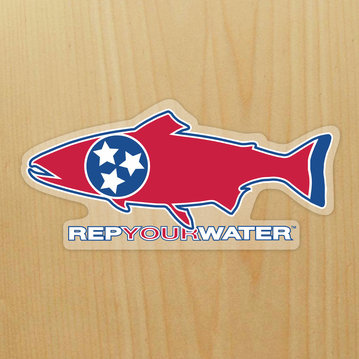A wood background has a sticker on it in the shape of a trout that has a circle filled with three stars inside of it and the words repyourwater below it