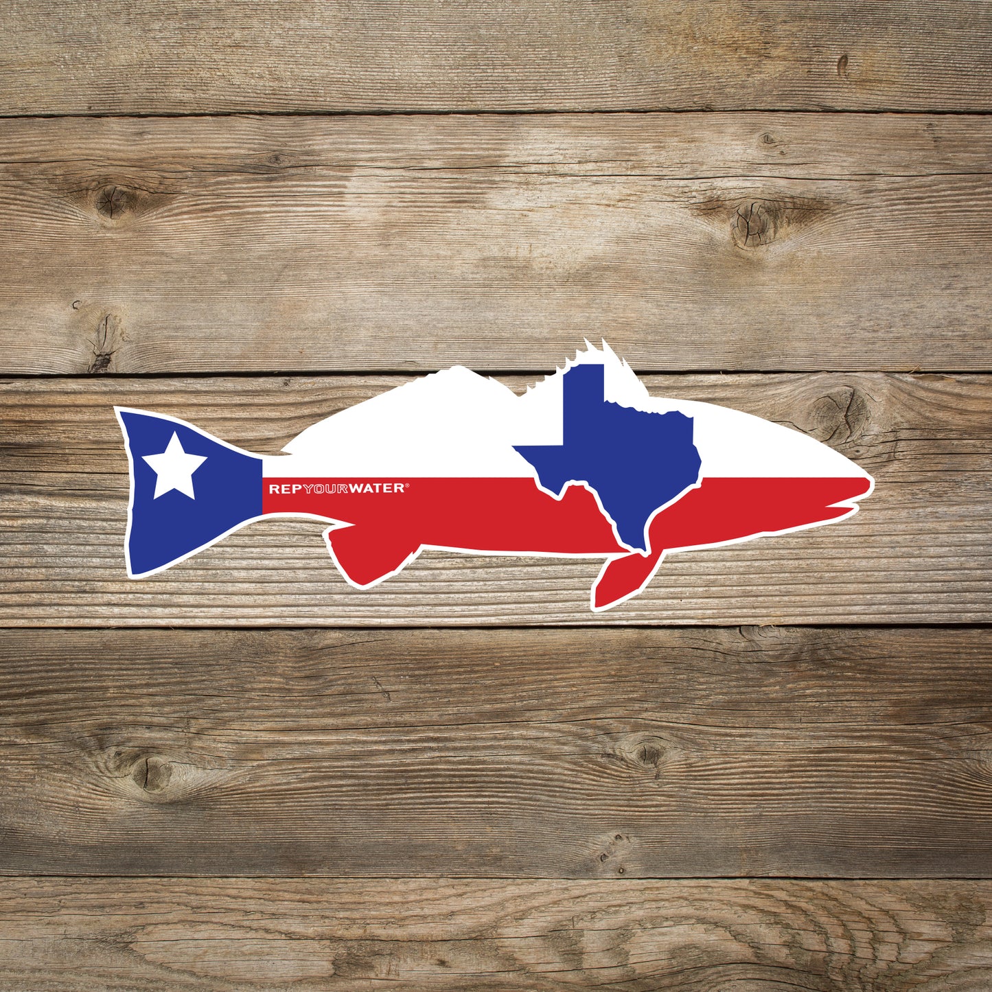 A wood background has a sticker in the shape of a redfish with the design and colors of the texas flag inside it as well as the state shape of texas. It also reads repyourwater