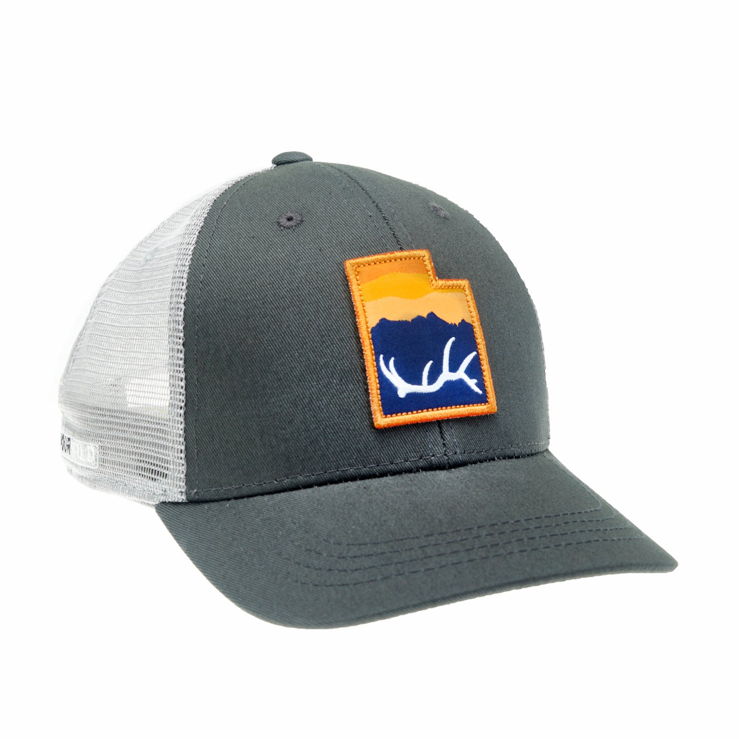 A hat with gray mesh and gray fabric has a patch in the shape of utah with an elk antler in front of a mountain and sunset